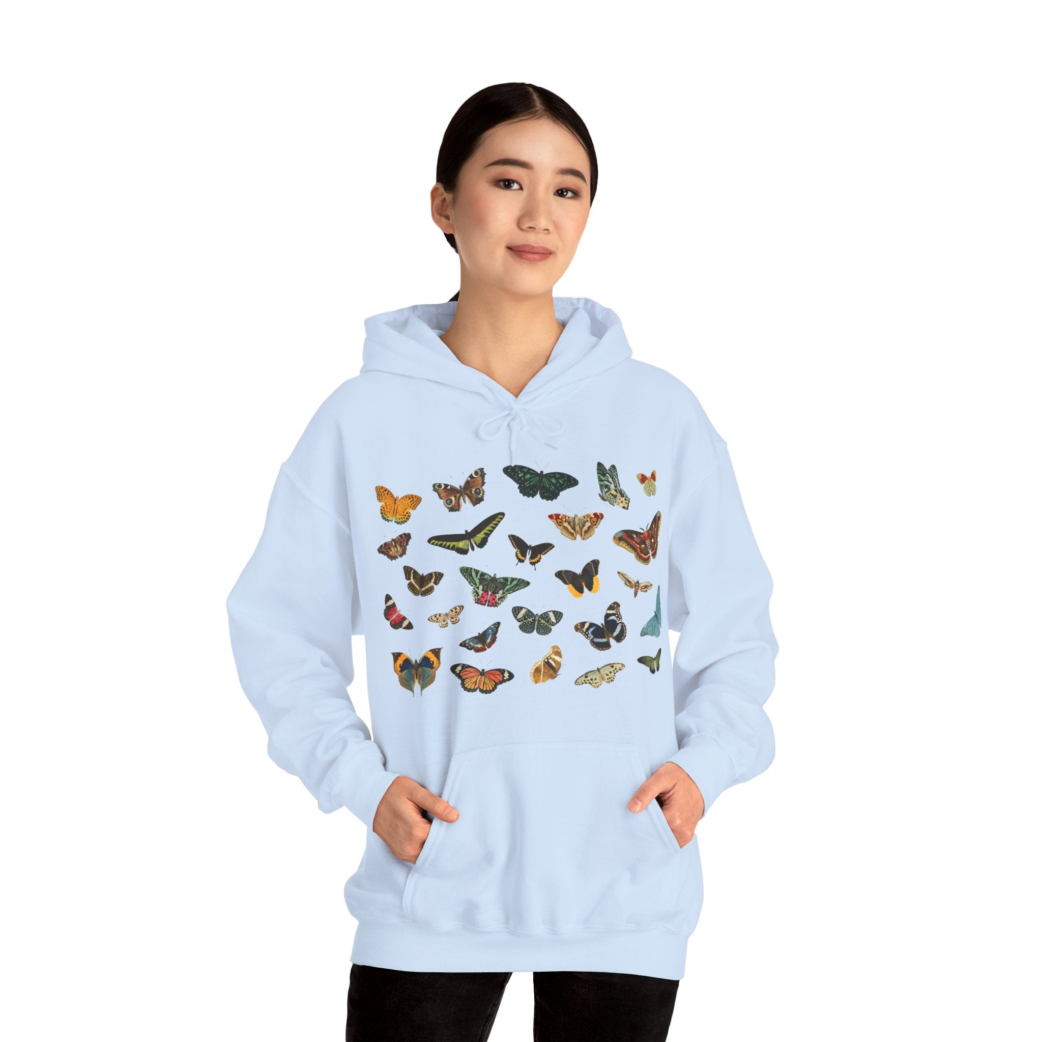 Light blue hoodie with butterfly patterns worn by a person on a white background. Gildan 18500 light blue hoodie