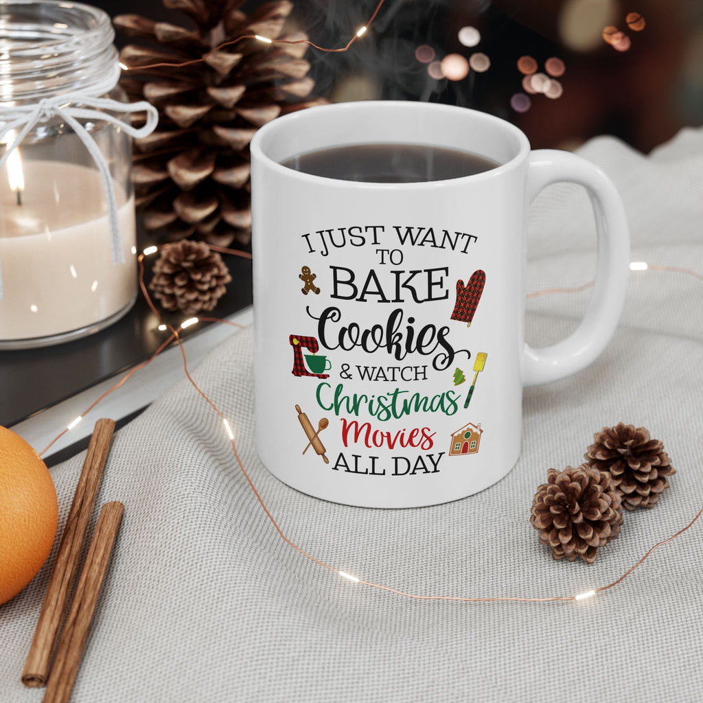 White 11 oz mug with Christmas-themed text on a table with decorative items, Holiday Baking Coffee Cup, Ginger Bread house, Kitchen Mixer