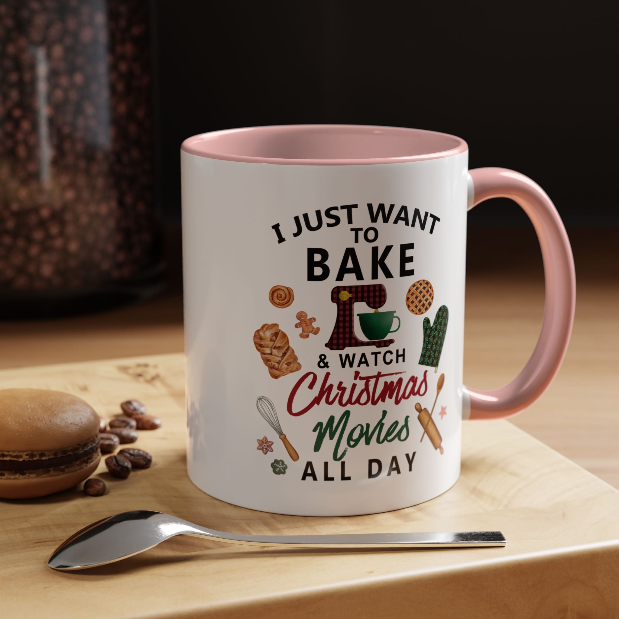 Pink 11 oz Mug with text 'I just want to bake & watch Christmas movies all day' on a wooden surface with cookies and coffee beans.