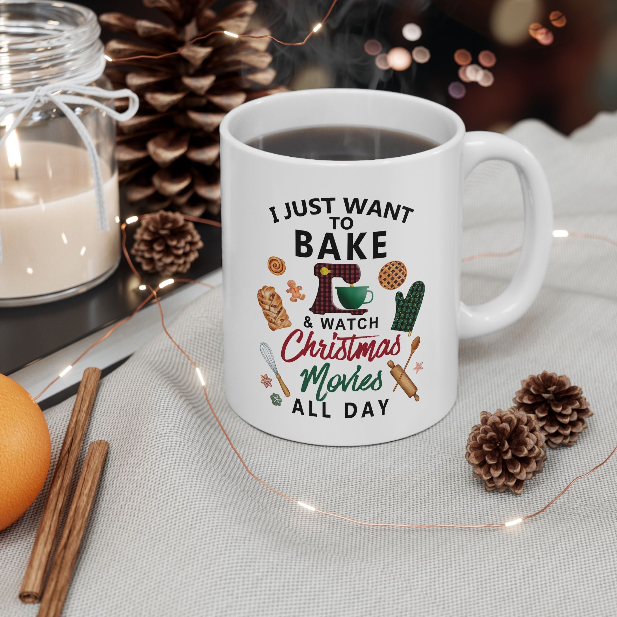 White mug with text and graphics on a table with festive decorations. Holiday baking cup